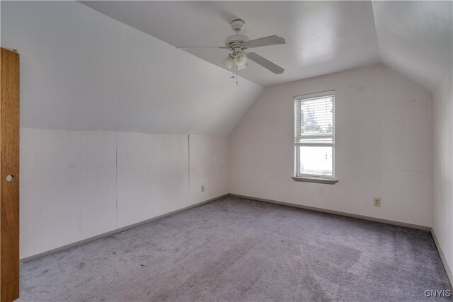 bonus room with light carpet, ceiling fan, and vaulted ceiling