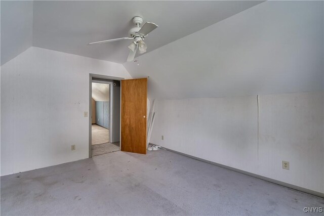 additional living space featuring light colored carpet, lofted ceiling, and ceiling fan