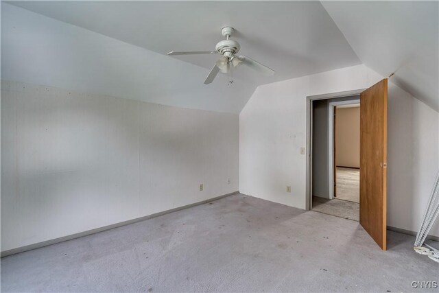 additional living space with light carpet, ceiling fan, and vaulted ceiling