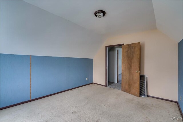 additional living space with lofted ceiling and light colored carpet