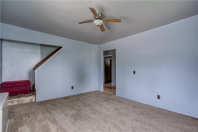 unfurnished living room with light carpet and ceiling fan