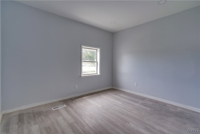 spare room featuring light hardwood / wood-style floors