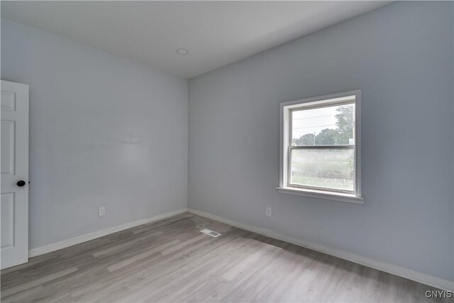 unfurnished room with wood-type flooring