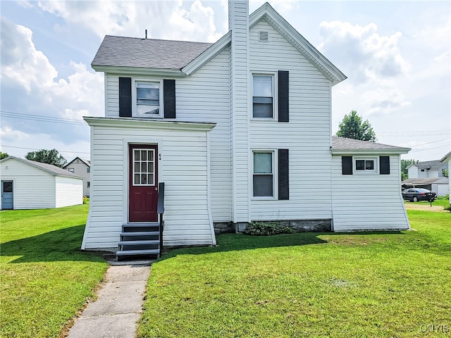 traditional home featuring entry steps, a shingled roof, a chimney, and a front yard