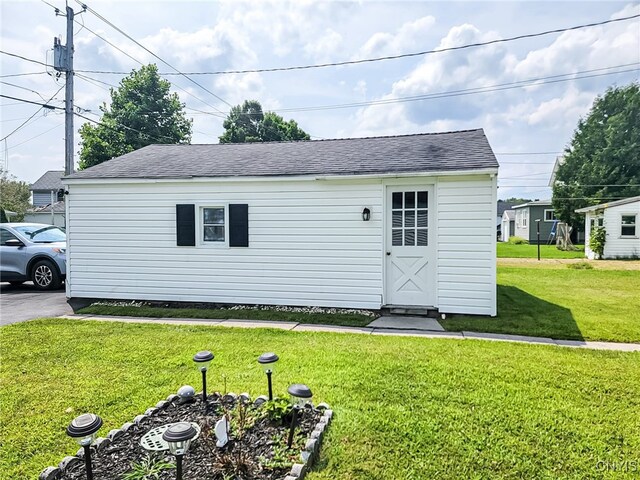 view of outbuilding with a yard