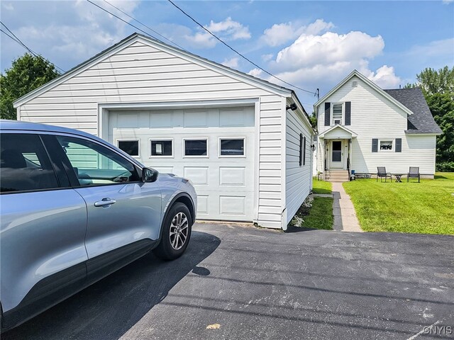 garage featuring a lawn