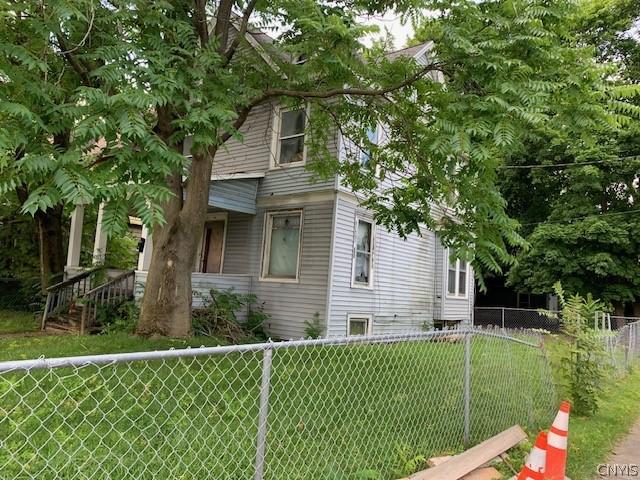 view of side of property with a yard