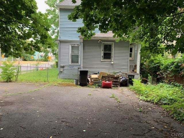 back of house featuring fence