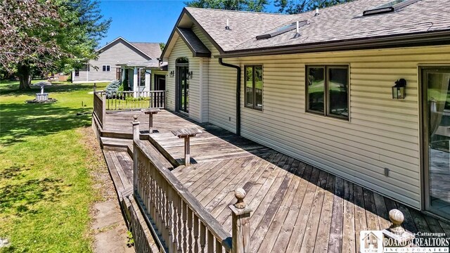 wooden deck with a lawn