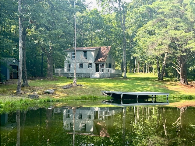 exterior space with a yard and a deck with water view