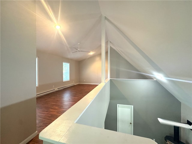 bonus room with vaulted ceiling, a baseboard radiator, ceiling fan, and hardwood / wood-style floors