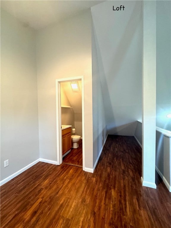 additional living space featuring dark hardwood / wood-style flooring and vaulted ceiling