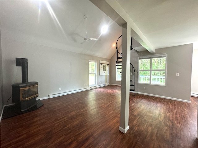 unfurnished living room with dark hardwood / wood-style flooring, a wealth of natural light, and a wood stove