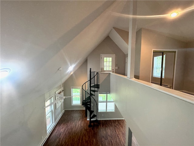 additional living space featuring lofted ceiling and hardwood / wood-style floors