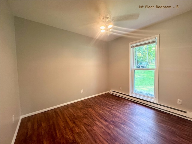 spare room with a baseboard radiator, ceiling fan, and dark hardwood / wood-style flooring