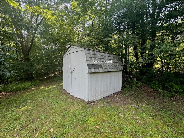 view of outbuilding featuring a yard