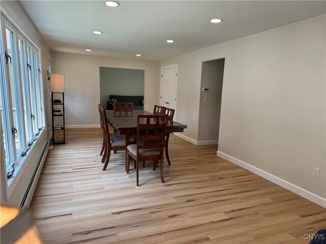 dining room featuring light hardwood / wood-style flooring and baseboard heating