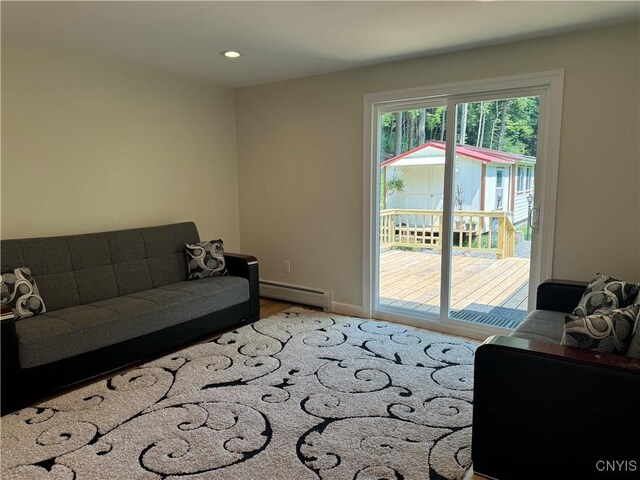 living room featuring a baseboard radiator and hardwood / wood-style flooring