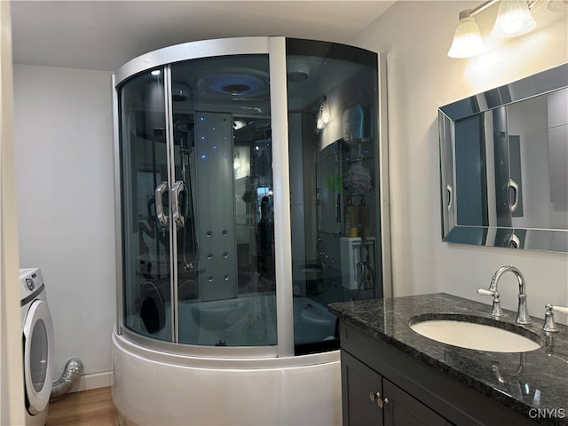 bathroom featuring vanity, washer / dryer, and wood-type flooring