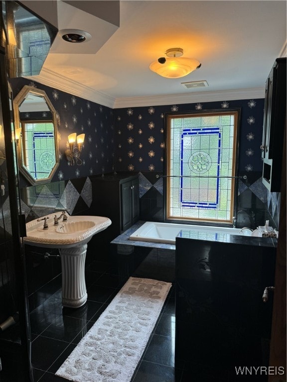 bathroom featuring sink, tiled bath, crown molding, and tile patterned flooring