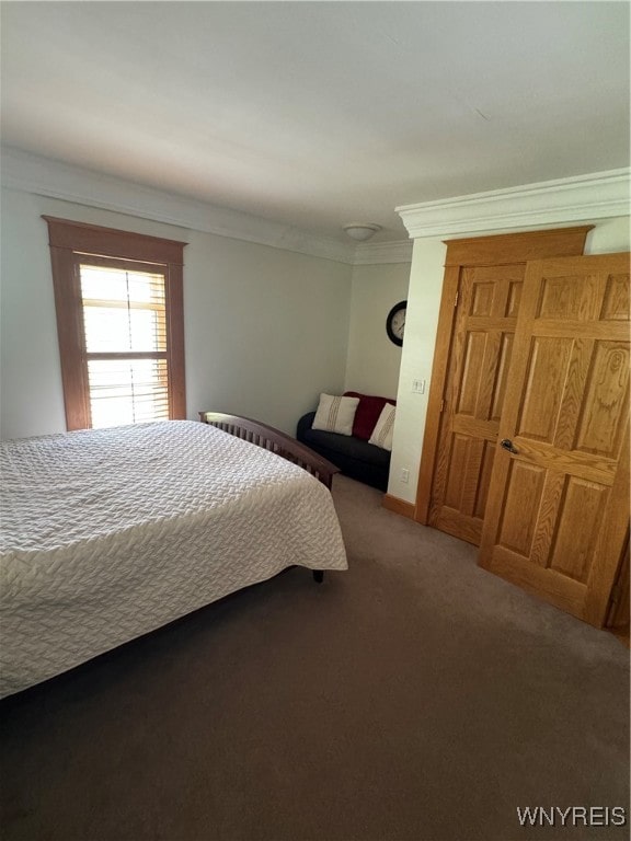 carpeted bedroom with ornamental molding