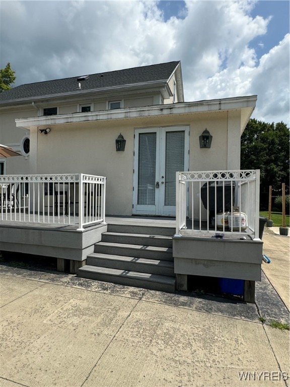 back of house with a wooden deck and french doors