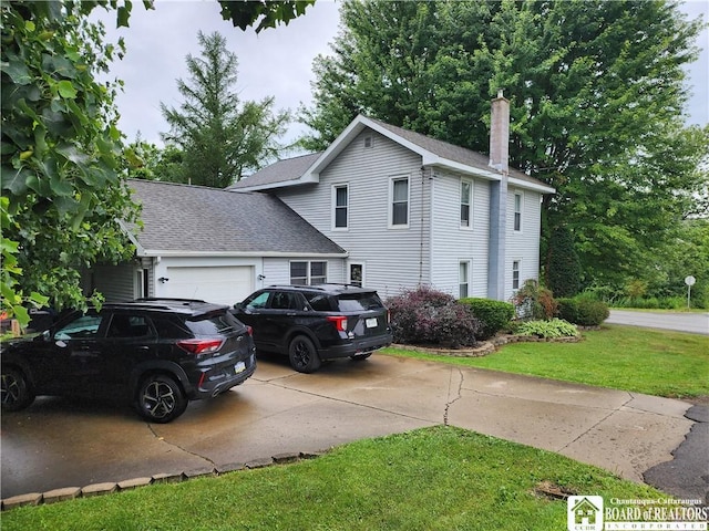 view of front of property with a garage and a front lawn