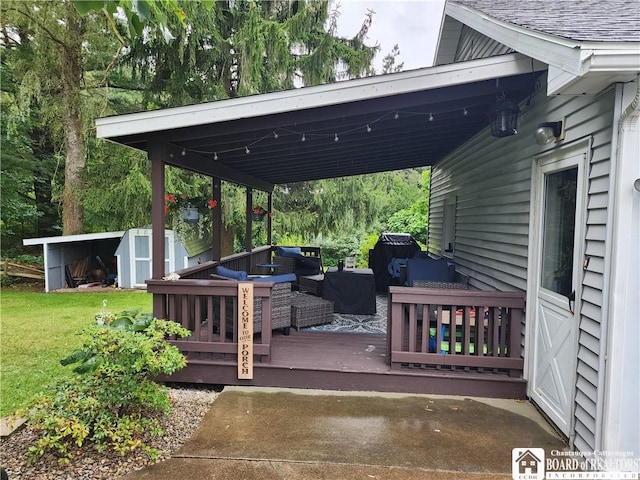 view of patio with a grill, a storage shed, and a wooden deck