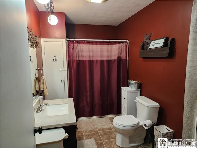 bathroom featuring toilet, vanity, tile patterned flooring, and a shower with shower curtain