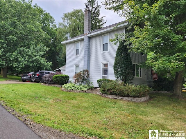 view of side of home featuring a lawn