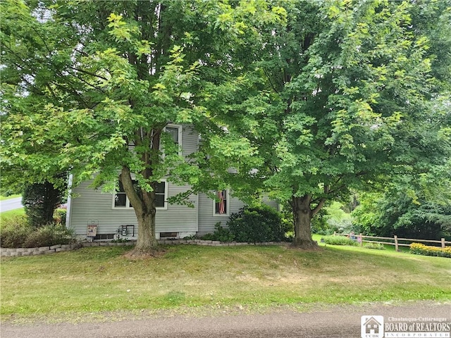 view of side of home featuring a yard