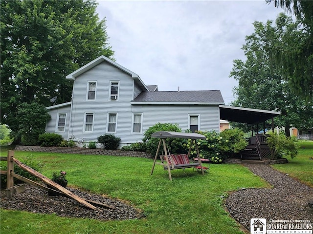 rear view of property with a yard