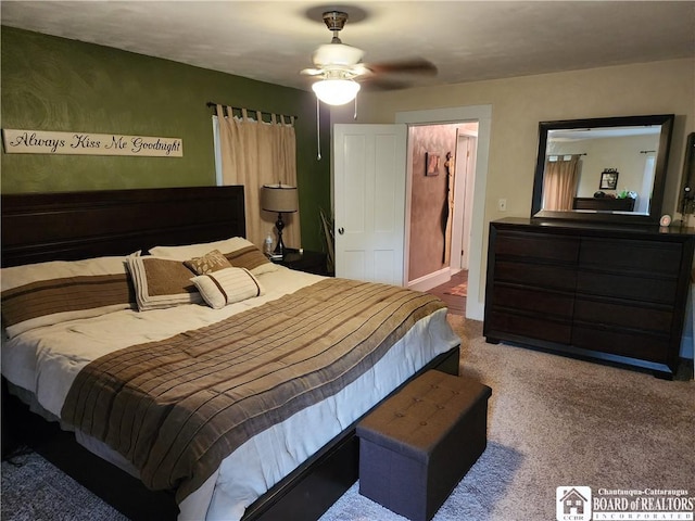 bedroom featuring ceiling fan, carpet flooring, and a spacious closet