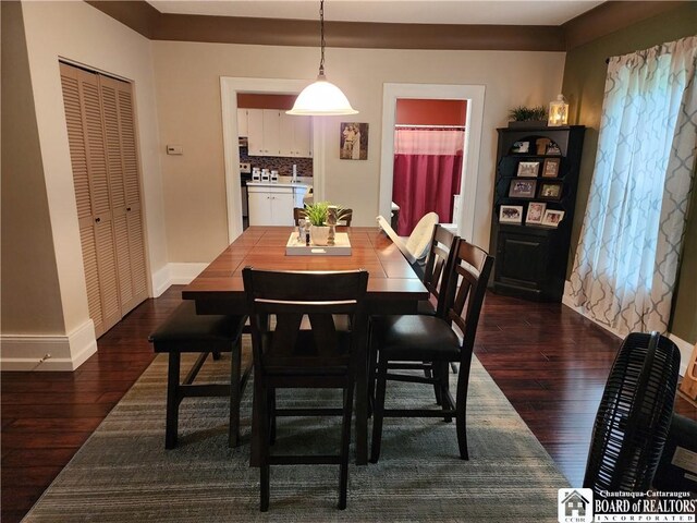 dining space with dark hardwood / wood-style flooring