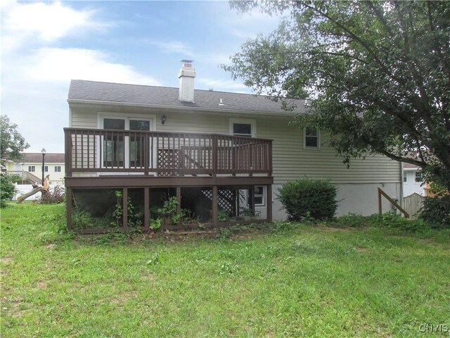 back of house featuring a deck and a lawn