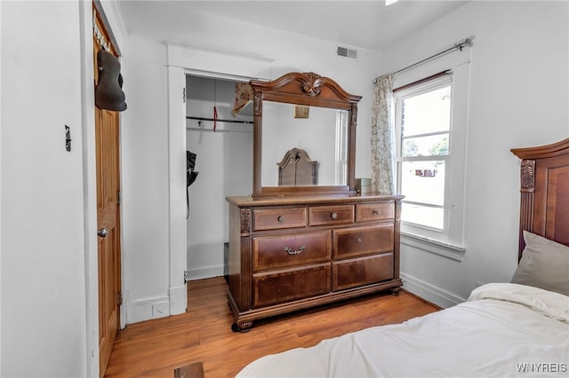 bedroom featuring light hardwood / wood-style floors and a closet