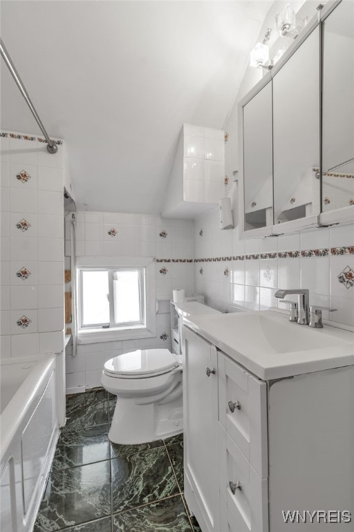 full bathroom featuring vanity, shower / tub combination, tile walls, and toilet