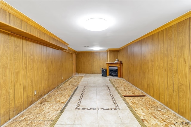 bonus room with tile patterned flooring and wood walls