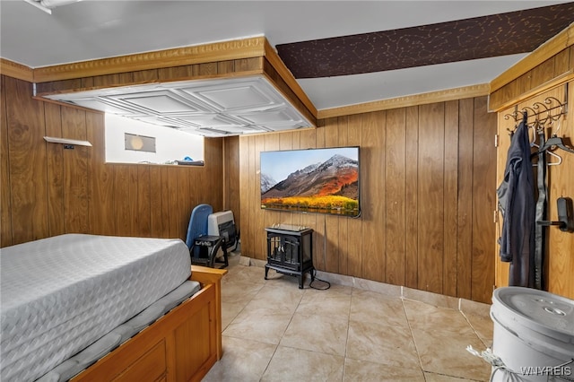 tiled bedroom featuring wooden walls and a wood stove