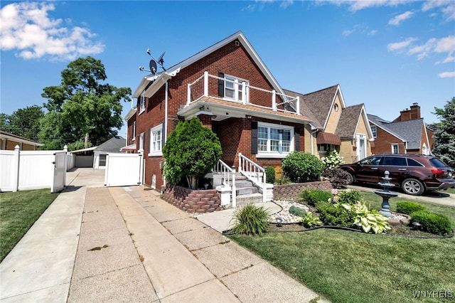 view of front of property featuring a garage, an outbuilding, and a front lawn