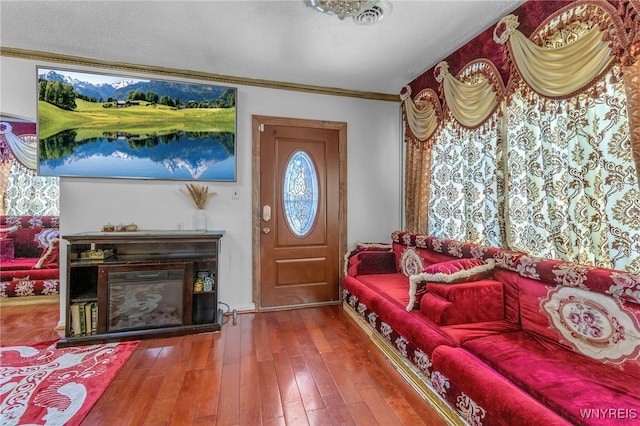 foyer with hardwood / wood-style flooring and ornamental molding