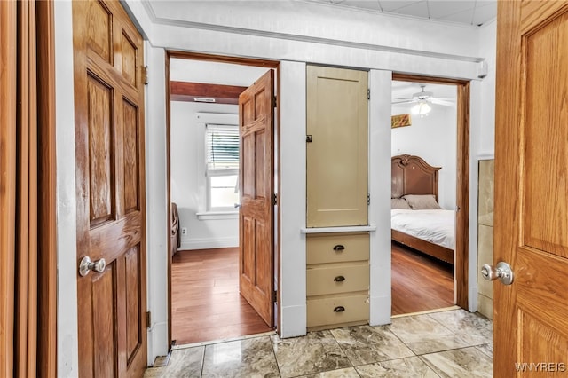 hallway featuring crown molding