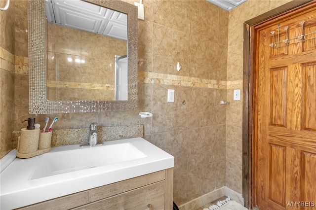 bathroom featuring vanity and tile walls