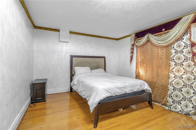 bedroom featuring hardwood / wood-style flooring and ornamental molding