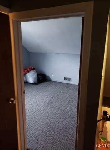 bonus room featuring carpet flooring and vaulted ceiling