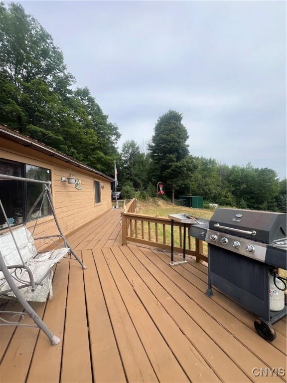 wooden deck featuring a grill