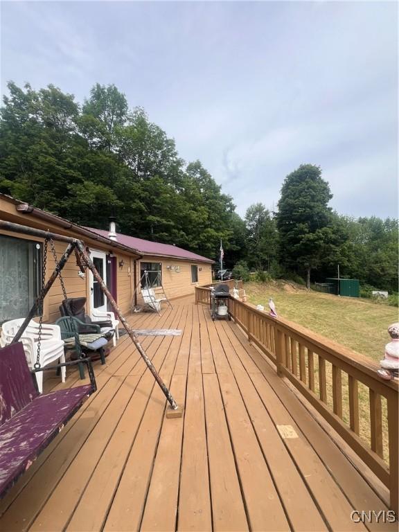 wooden terrace with a lawn