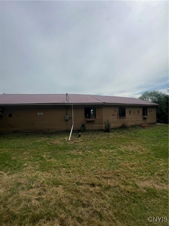 rear view of house with a yard