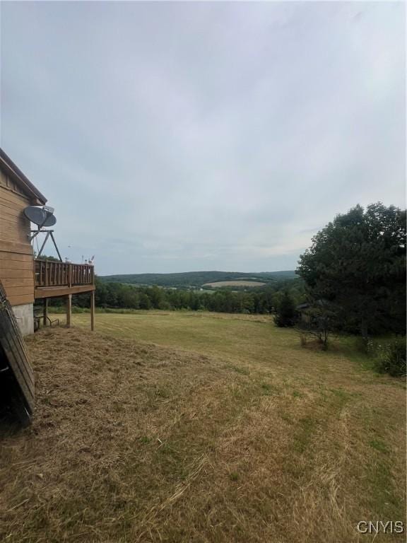 view of yard featuring a rural view and a deck