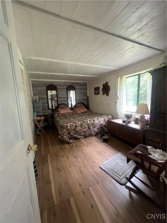 bedroom with wood ceiling and wood-type flooring